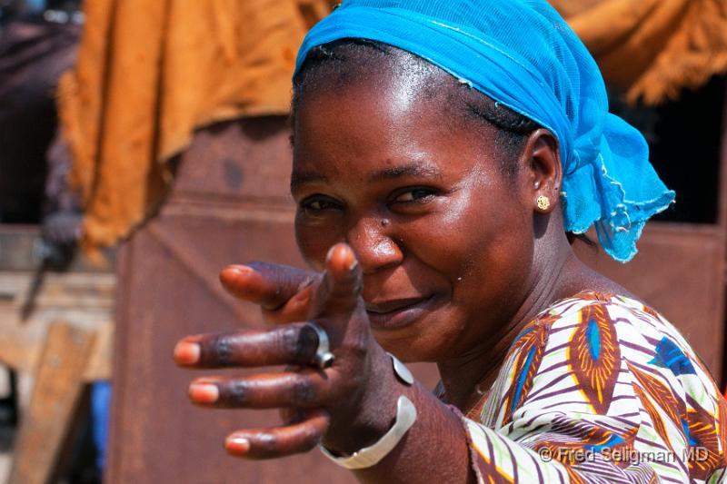 20090529_114229 D300 P1 P1.jpg - Lady pointing at me as I pass her.  Village near Dakar